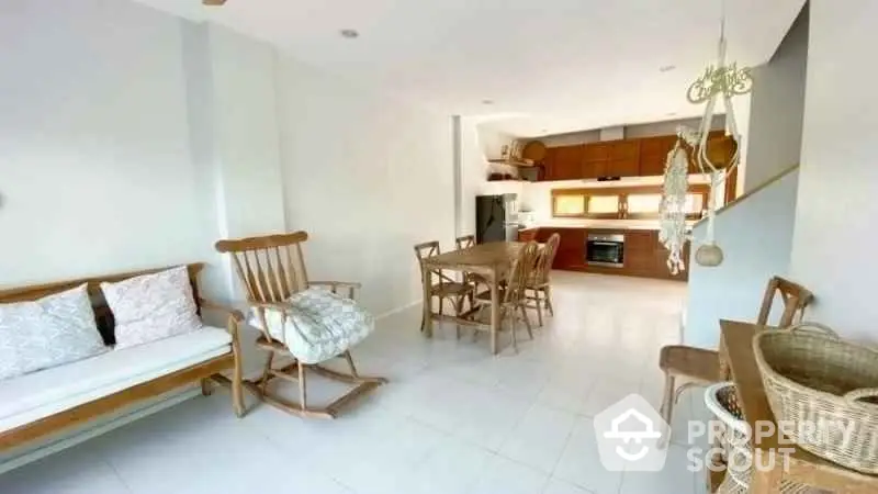 Spacious open-plan living and dining area with modern kitchen and natural light.