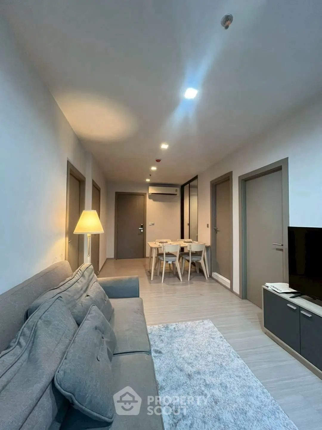 Modern living room with cozy seating and dining area, perfect for relaxation and entertainment.