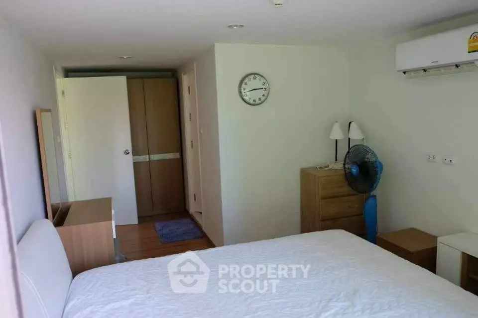 Cozy bedroom with modern furnishings and air conditioning in a bright, minimalist design.