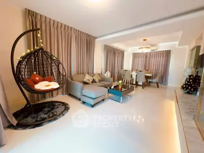 Spacious modern living room with elegant dining area and stylish hanging chair