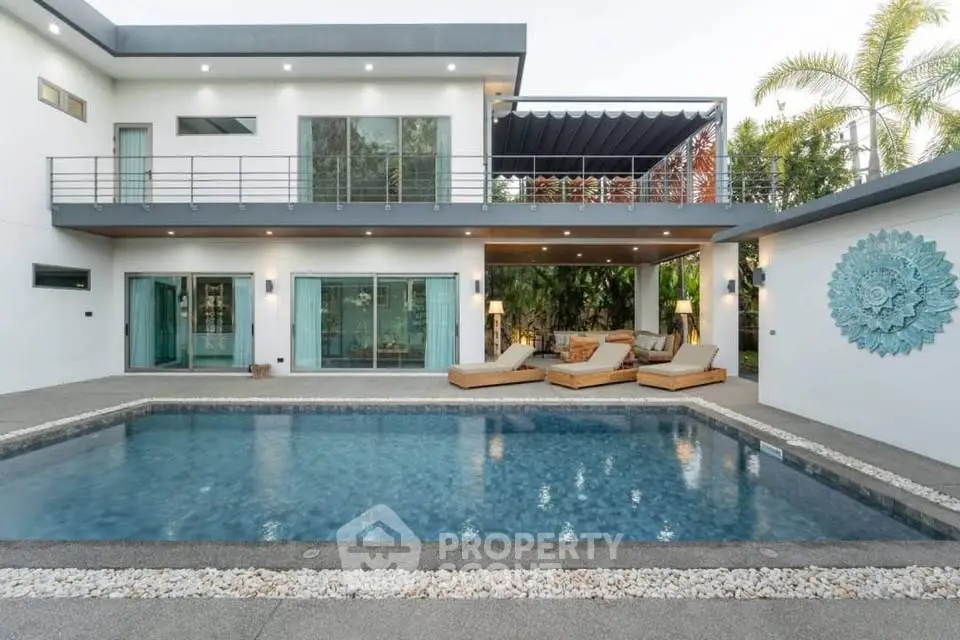 Luxurious modern villa with private pool and spacious outdoor lounge area, perfect for relaxation.