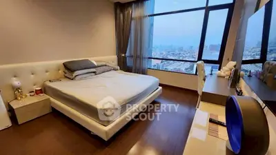 Spacious bedroom with city view and modern furnishings