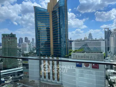 Stunning cityscape view from a high-rise balcony overlooking modern skyscrapers and urban skyline.