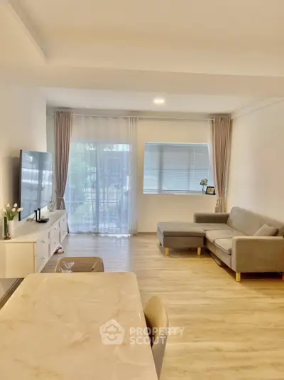 Spacious modern living room with natural light and stylish furniture