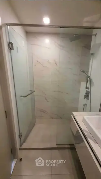 Modern bathroom with glass shower and sleek vanity