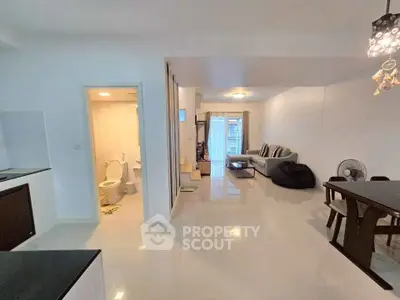 Spacious open-plan living room with modern decor and dining area
