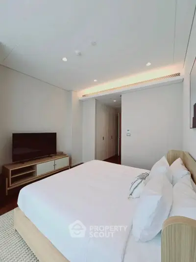 Spacious modern bedroom with sleek design and natural light