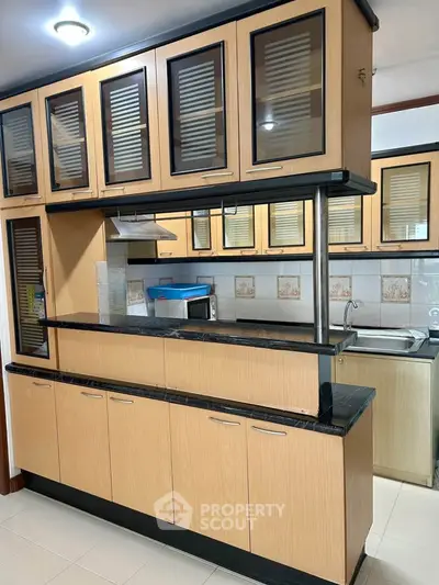 Modern kitchen with sleek wooden cabinets and open layout design