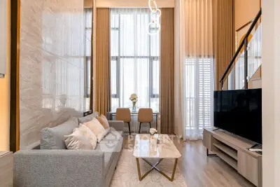 Luxurious modern living room with high ceilings and elegant decor