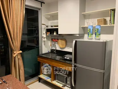 Modern kitchen with sleek appliances and balcony view, featuring a stylish open layout and contemporary design.