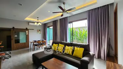 Spacious living room with modern decor and large windows for natural light
