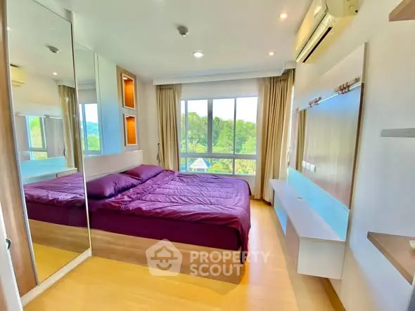 Modern bedroom with large window and scenic view, featuring mirrored wardrobe and sleek design.