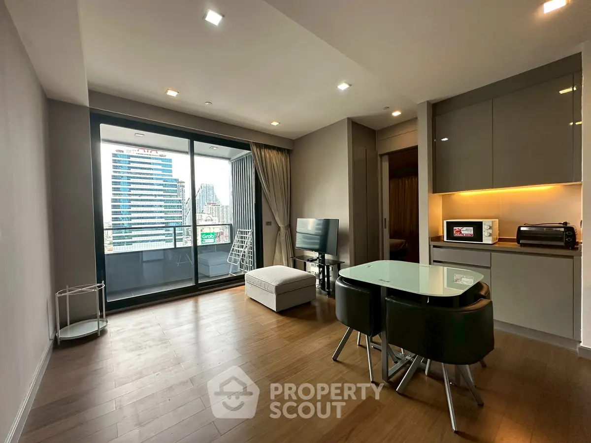 Modern living room with open layout and city view balcony in high-rise apartment.