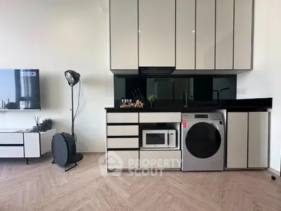 Modern kitchen with sleek cabinetry, integrated appliances, and stylish decor in a contemporary apartment.