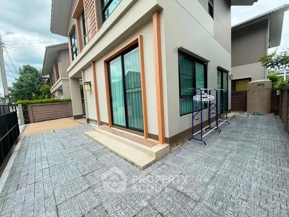 Modern two-story house with spacious outdoor area and sleek design.