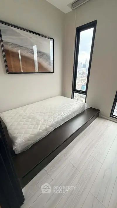 Modern minimalist bedroom with city view and sleek flooring