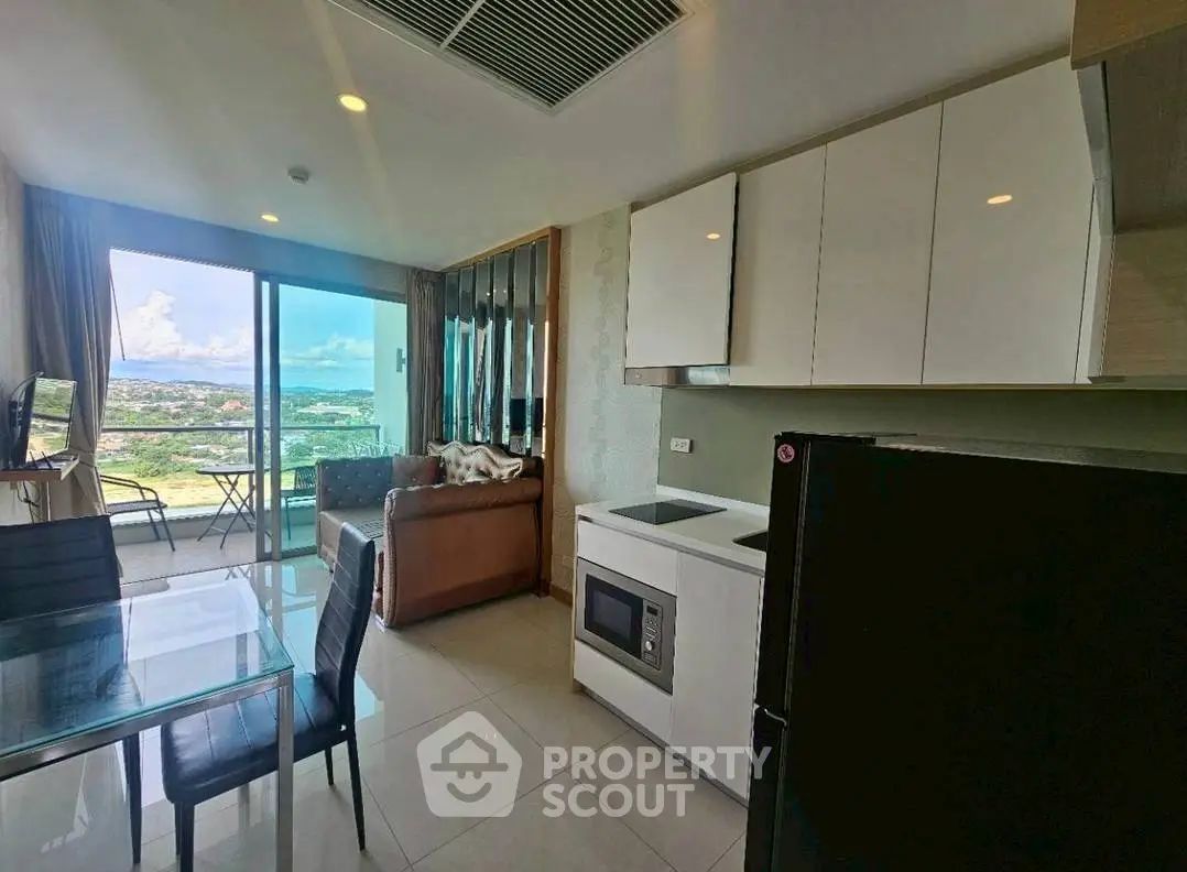 Modern open-layout living room with kitchen and stunning balcony view
