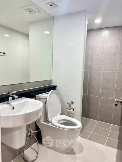 Modern bathroom with sleek fixtures and neutral tiles, perfect for a contemporary home.