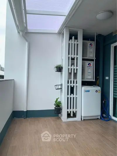 Spacious balcony with modern design and utility area, perfect for urban living.