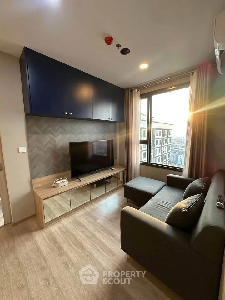 Modern living room with stylish decor and large window offering city view