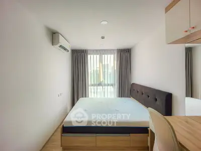 Modern minimalist bedroom with large window and stylish furnishings