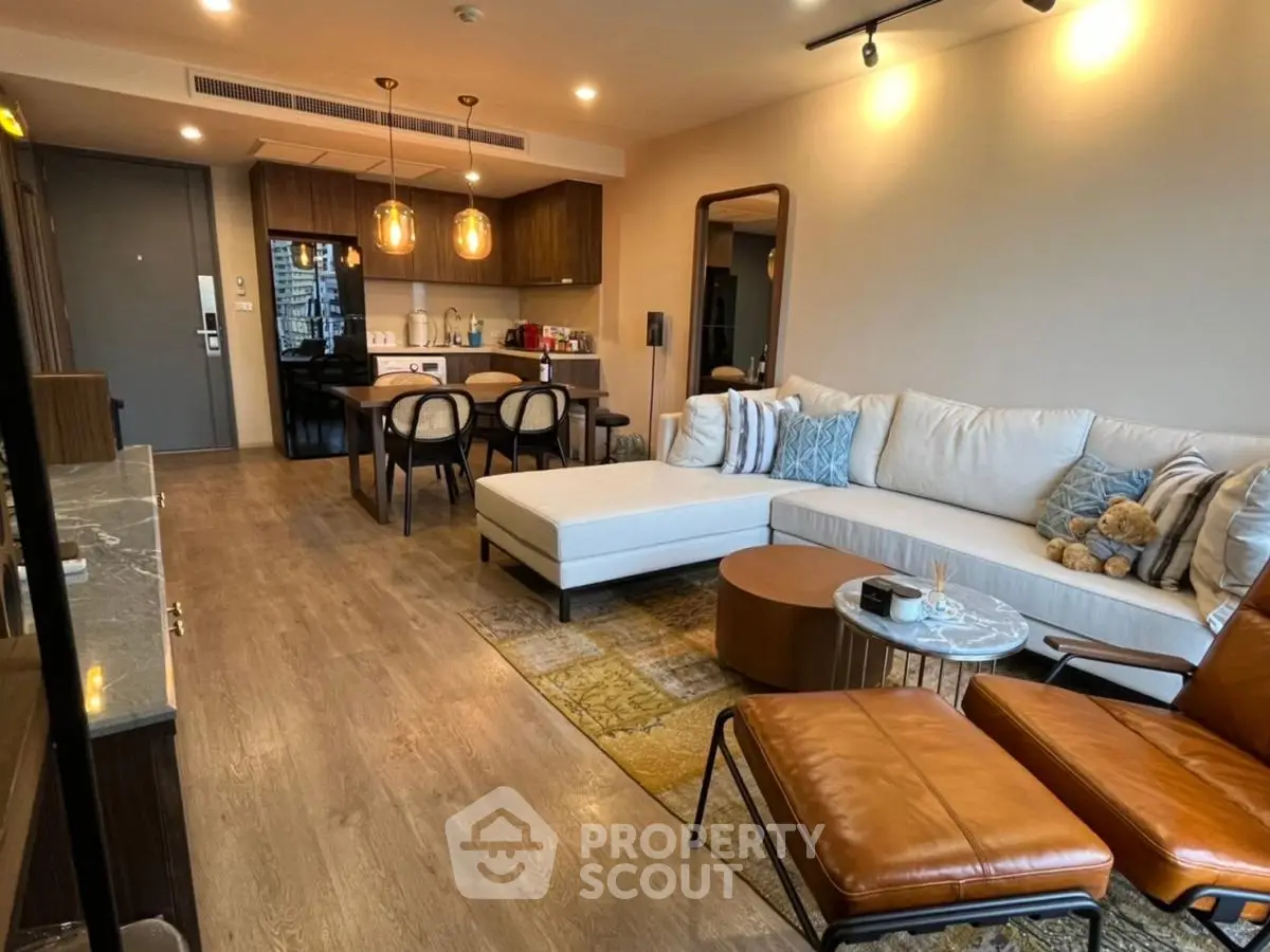 Modern living room with open layout, stylish furniture, and warm lighting in a contemporary apartment.
