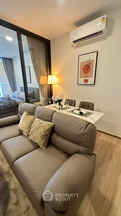 Modern living room with cozy sofa and dining area in stylish apartment