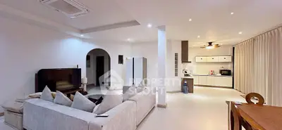 Spacious open-plan living room with modern kitchen and elegant decor
