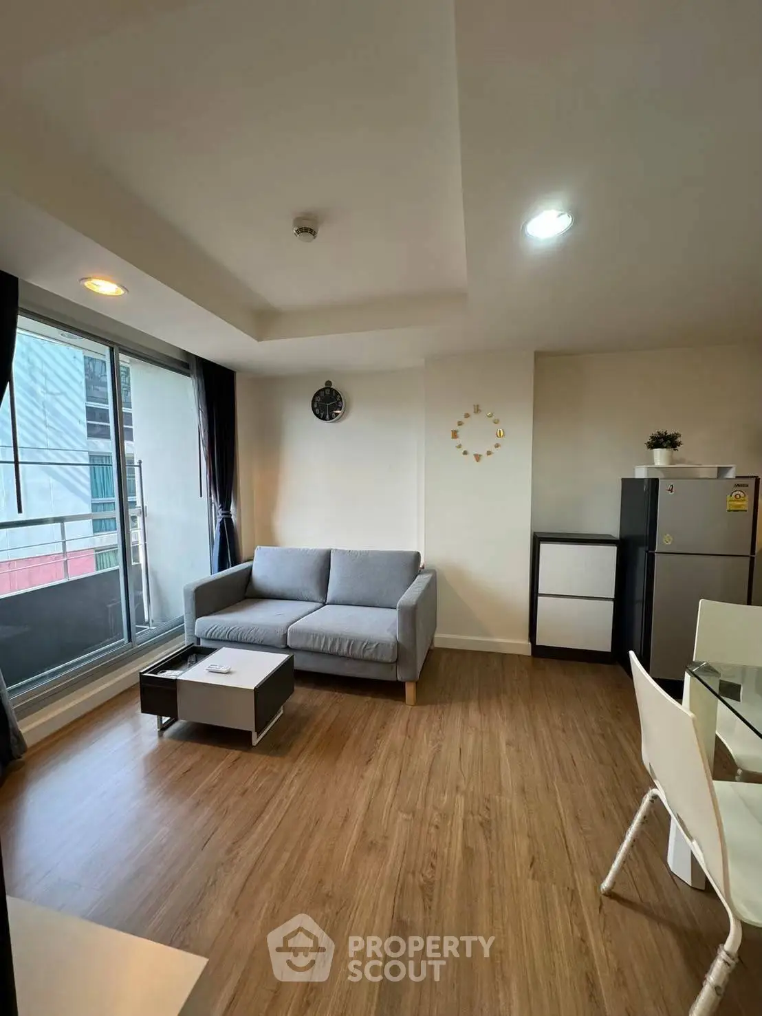 Modern living room with sleek furniture and large windows in a stylish apartment.