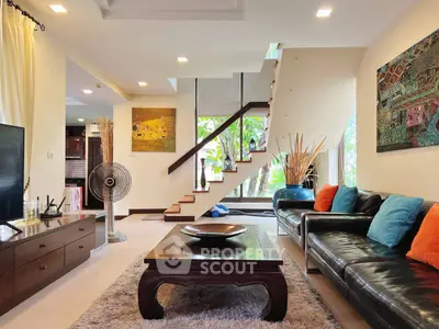 Stylish living room with modern decor and staircase, perfect for family gatherings.