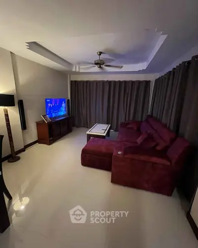 Spacious living room with modern decor and entertainment setup