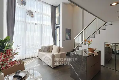 Luxurious modern living room with high ceilings and elegant staircase