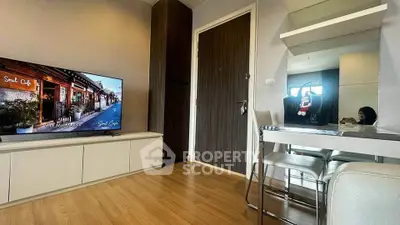 Modern living room with sleek TV setup and dining area, featuring stylish decor and wooden flooring.