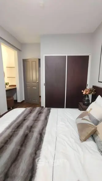 Modern bedroom with stylish decor and built-in closet