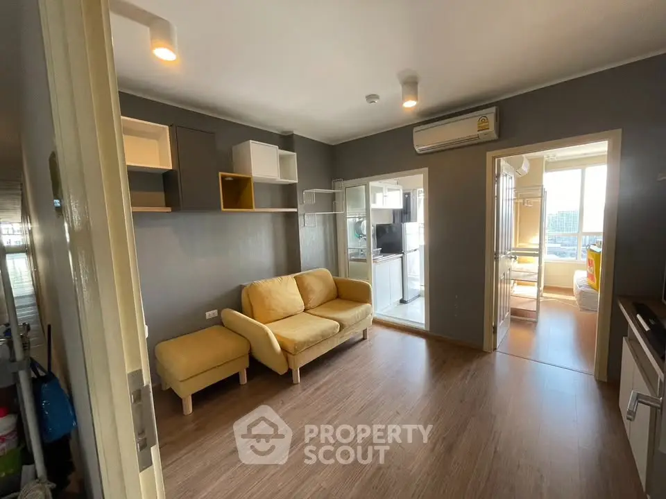 Modern living room with cozy yellow sofa and wooden flooring