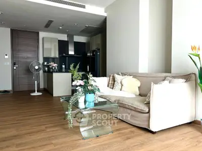 Modern open-plan living room with stylish furniture and sleek kitchen design