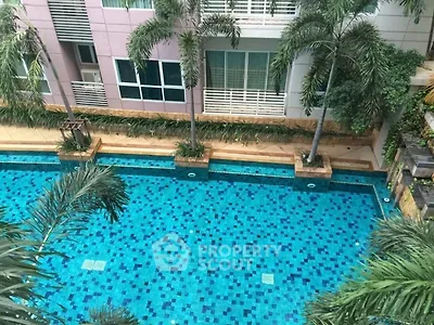 Luxurious apartment pool with palm trees and modern building facade