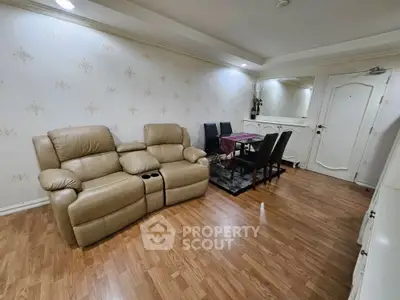 Cozy living room with leather recliners and dining area, perfect for relaxation and entertaining.