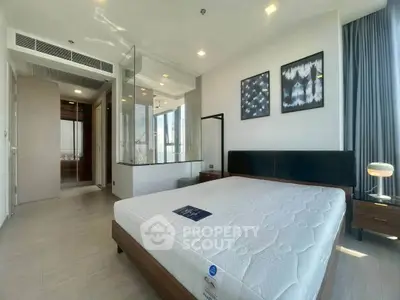 Modern bedroom with large windows and stylish decor in a high-rise apartment.