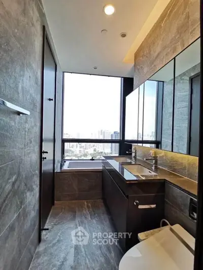 Luxurious bathroom with city view, featuring dual sinks and modern design.