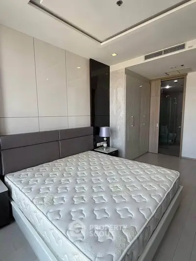 Modern bedroom with stylish decor and spacious layout in luxury apartment.