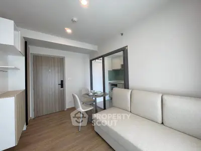 Modern living room with cozy sofa and dining area in open layout apartment