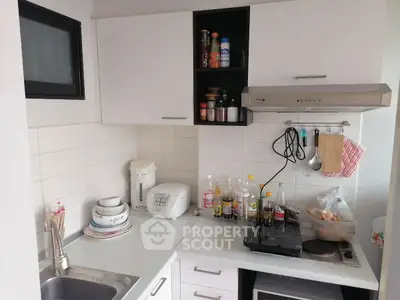 Compact kitchen with modern appliances and open shelving for efficient use of space.