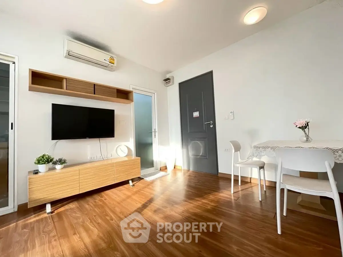 Bright modern living room with wooden flooring and stylish furniture