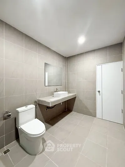 Spacious modern bathroom with sleek fixtures and neutral tile design