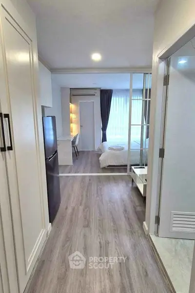 Modern apartment interior with sleek design, featuring a cozy bedroom and stylish kitchen area.