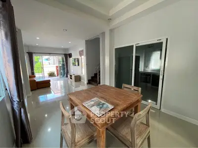 Spacious open-plan living and dining area with modern decor and natural light