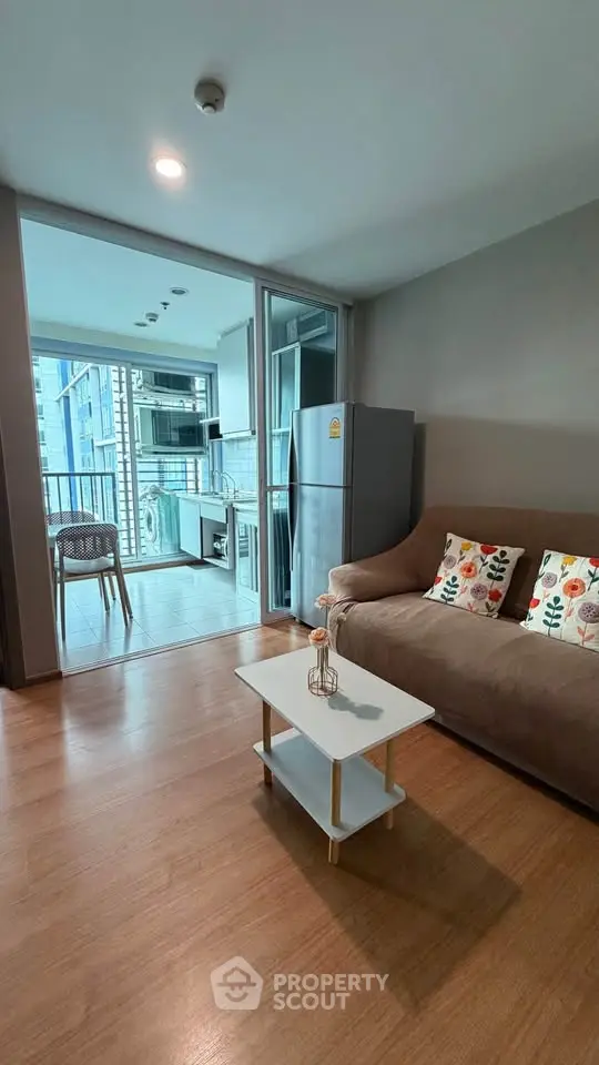 Modern living room with cozy sofa and open kitchen layout in urban apartment
