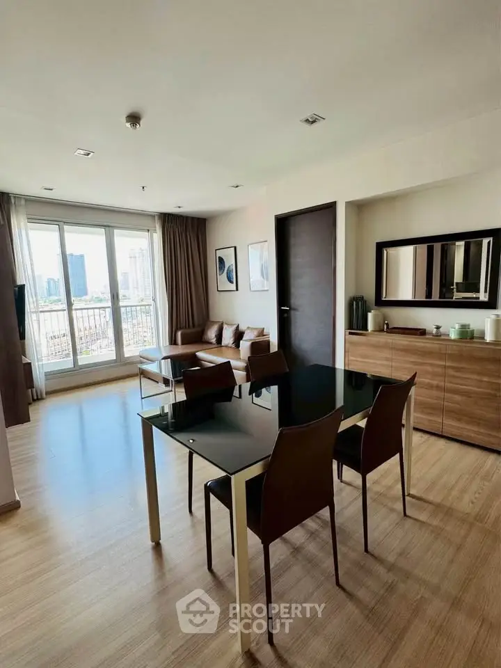 Modern living room with city view, stylish furniture, and natural light.