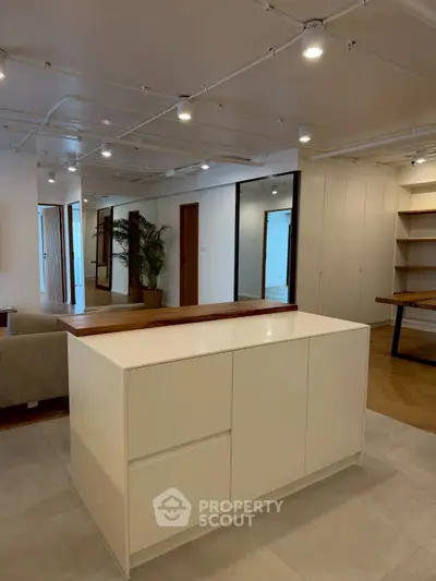 Spacious modern living area with stylish lighting and sleek cabinetry, perfect for contemporary living.